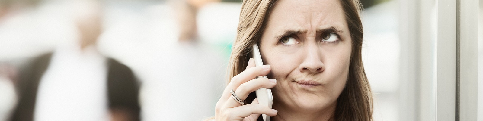 Woman on a cell phone looking suspicious of the call