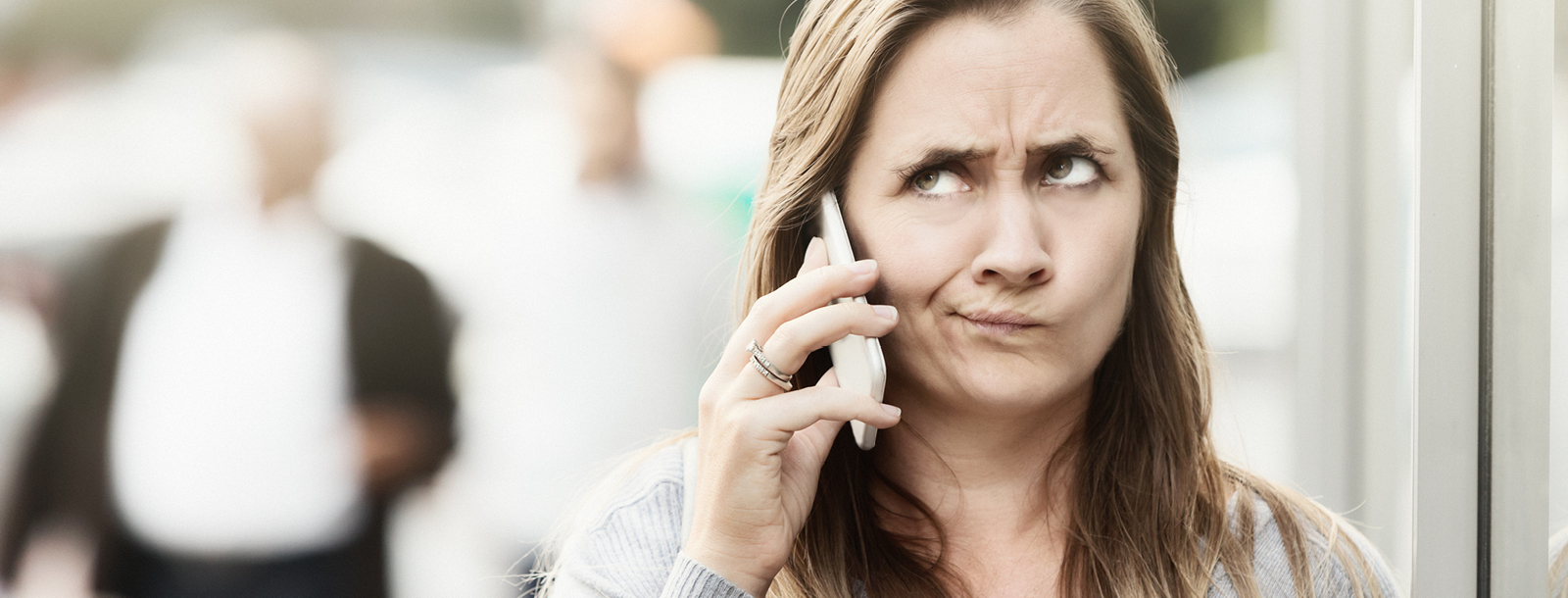 Woman on a cell phone looking suspicious of the call